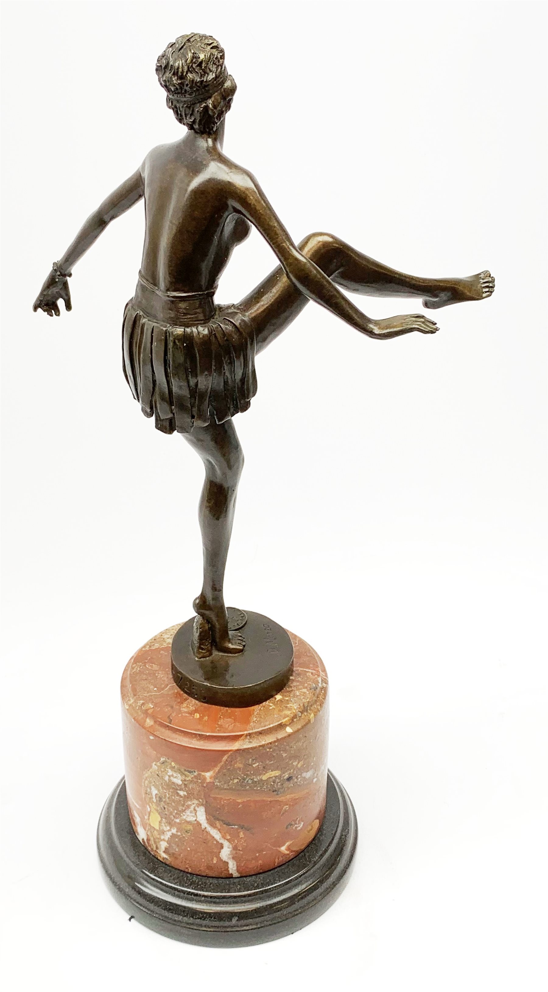 An Art Deco style bronze after D Alonzo, modelled as a female hoop dancer, with impressed mark and foundry mark, raised upon a cylindrical marble base, overall H47cm. 