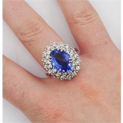 18ct white gold oval sapphire and round brilliant cut diamond cluster ring, Sheffield 2000, sapphire approx 3.75 carat, total diamond weight approx 0.70 carat