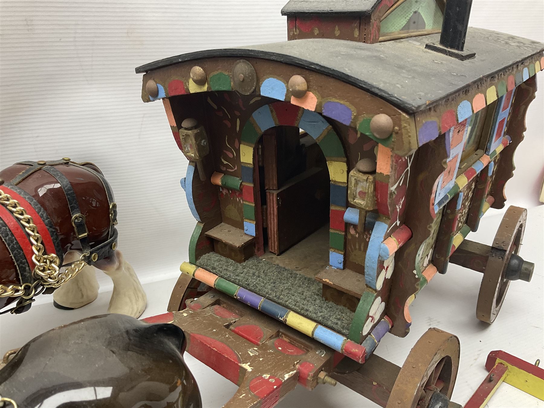 Two ceramic shire horse and gypsy caravans, together with horse brasses 