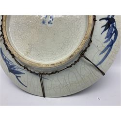 20th century Chinese blue and white crackle glaze charger, decorated with peonies, prunus blossom, and rockwork, within simulated bronze border, with character mark verso, D34cm