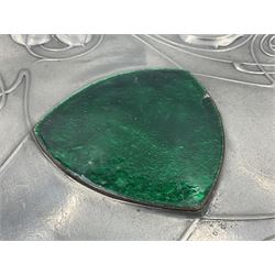 Liberty & Co Tudric pewter Bollelin tray, designed by Archibald Knox, of circular form with shaped edge, cast in relief with foliate tendrils surrounding a green enamel cartouche, impressed beneath Made by Library & Co English Pewter 044, D25.5cm