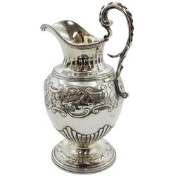 Victorian silver cream jug, the ovoid body repousse decorated with part fluting, flowering vines and C scrolls, with beaded rim and scroll handle, the whole upon a circular foot, hallmarked Charles Thomas Fox & George Fox, London 1843, H15.5cm, approximate weight 6.10 ozt (190 grams)