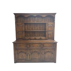 18th century design oak dresser, the projecting dentil cornice over two panelled cupboards, shelves and spice drawers, the base fitted with three drawers and three cupboards with pointed ogee fielded panels