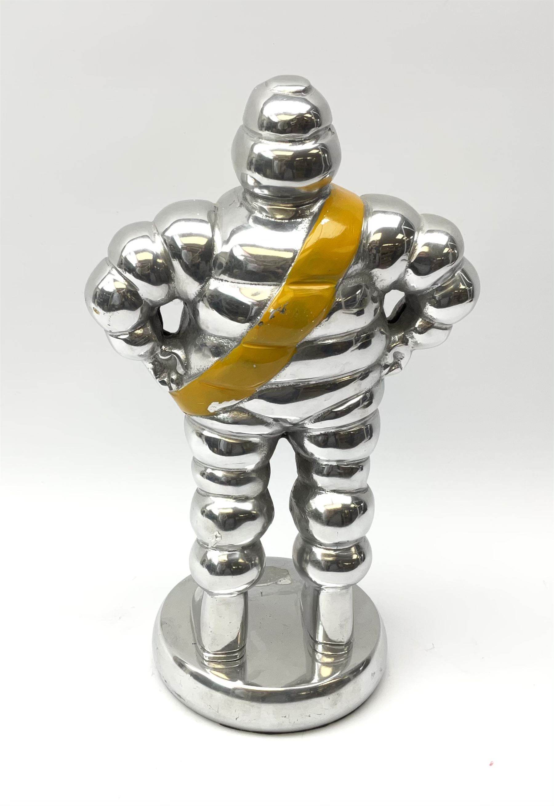 A polished aluminium Michelin man figure, H33.5cm.