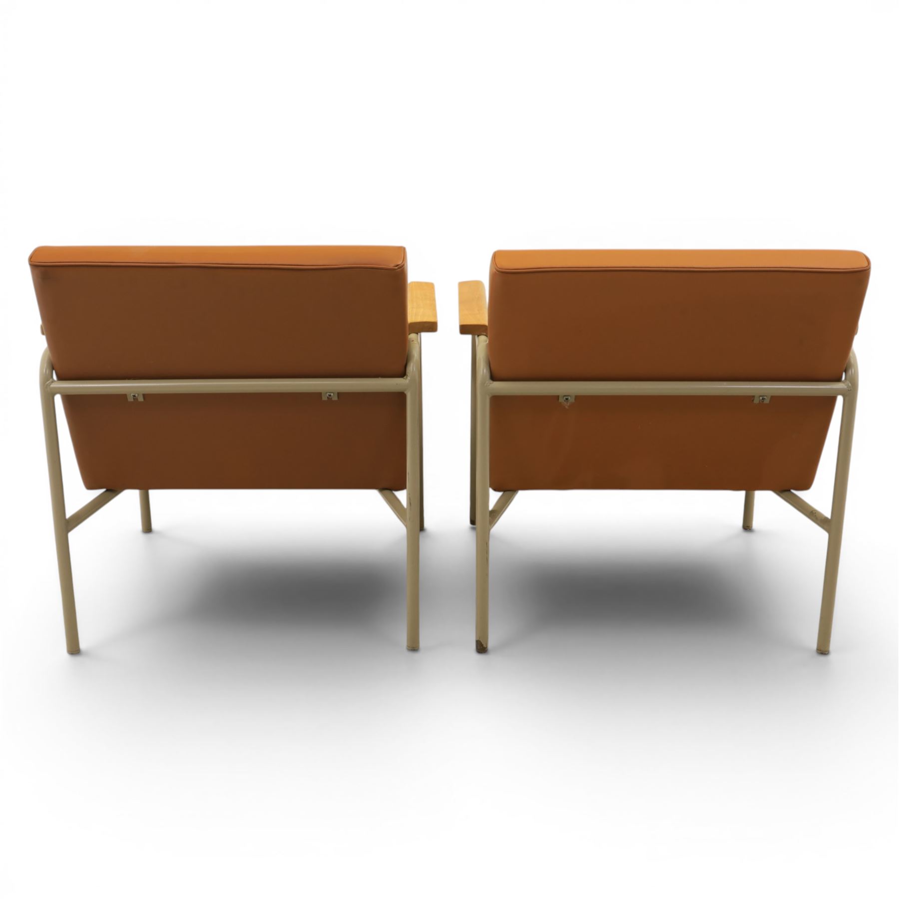 Pair of mid-20th century painted wrought metal easy armchairs with tan leather upholstery and teak armrests
