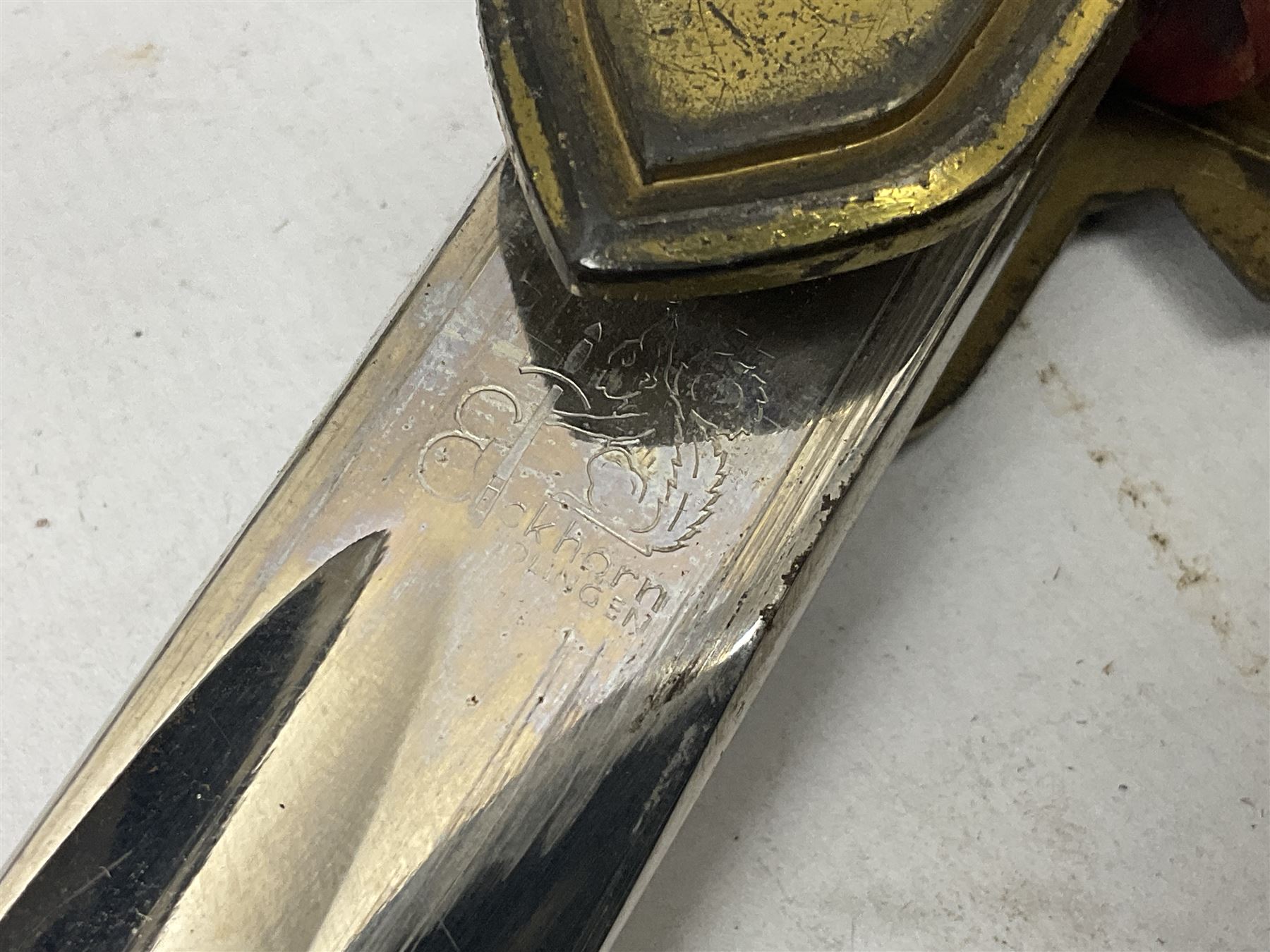 WW2 German Army Prinz Eugen Pattern Officers Dress Sword by Carl Eickhorn, the 80.5cm slightly curving fullered blade with makers name to the ricasso, gilt brass hilt with eagle to the cross-piece and relief of oakleaves to the ferrule, Prinz Eugen style down winged eagle to the pommel of the backstrap; grip retains the original wire binding; in original black painted scabbard with single hanging ring, leather hanger marked 'RZM M5/71 OLC' and silvered knot L97cm overall