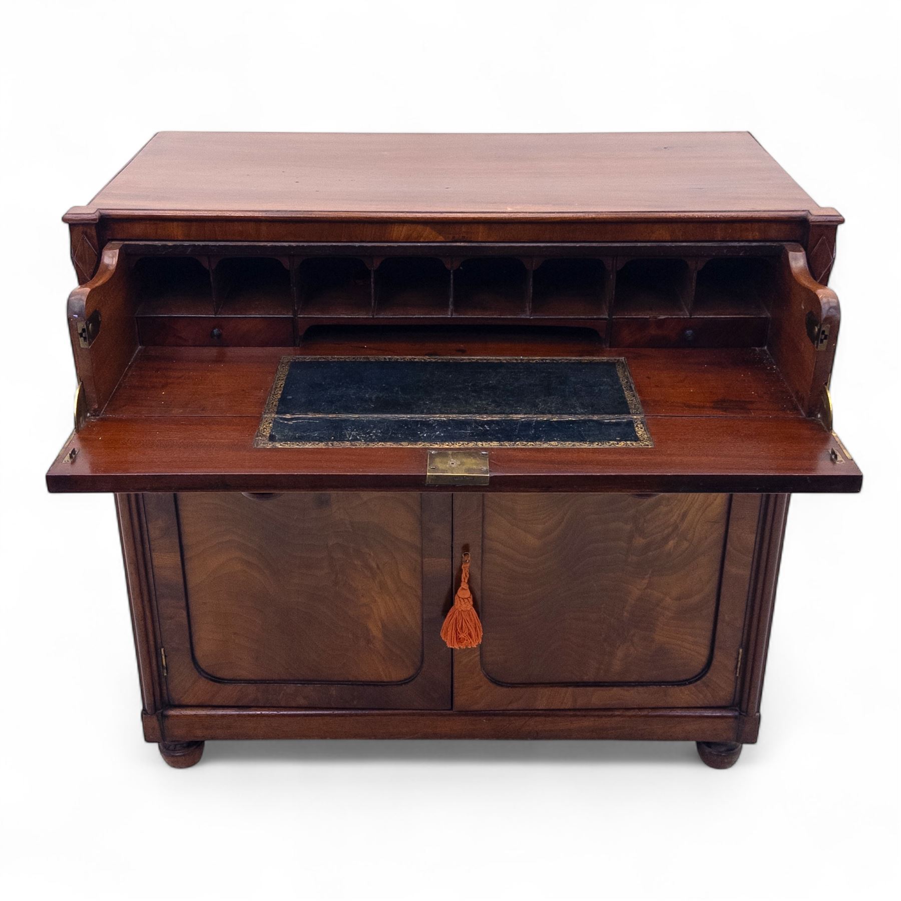 Regency mahogany secretaire cabinet, rectangular top over fitted secretaire drawer enclosing a tooled leather writing surface and pigeonholes, above a pair of panelled cupboard doors, raised on bracket feet