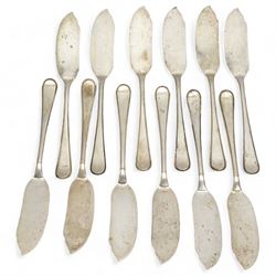 Set of twelve Dutch silver fish knives and eleven forks with reeded edge with Minerva Head duty mark and The Hague assay