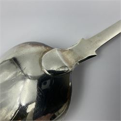 Victorian Newcastle silver Fiddle Shell pattern serving spoon, the terminal engraved with crest of a fist holding an arrow aloft, hallmarked Lister & Sons, Newcastle 1862, L31cm