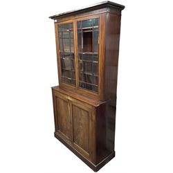 19th century mahogany bookcase on cupboard, fitted with two astragal glazed doors enclosing three shelves, above two cupboards, on skirted base