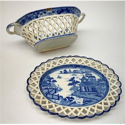 Mid 19th century blue and white transfer printed pearlware reticulated chestnut basket, of oval form with twin handles, decorated to the interior with figures before a classical temple within a garden setting, including handles W26cm, together with a mid 19th century blue and white transfer printed pearlware stand with reticulated edge, decorated with a Willow Pattern, L25cm, and a John and William Ridgeway blue and white transfer printed twin handled pierced basket, decorated with a pastoral scene containing figures at work, with printed mark beneath, including handles L25cm