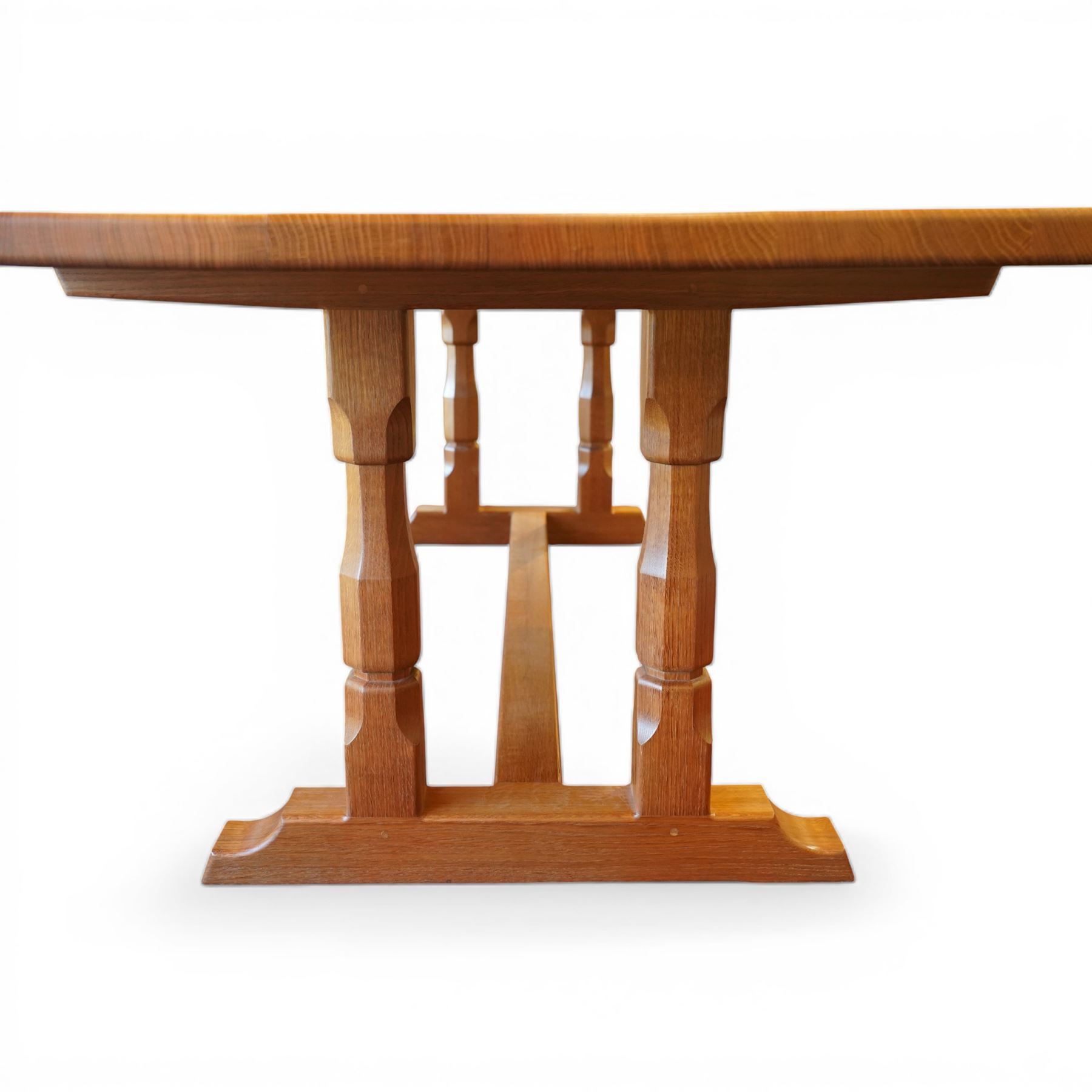 Knightman - oak rectangular refectory four pillar dining table, rectangular plank top, over twin pillar supports to both ends, united by a single stretcher with sled feet, with carved knight signature, by Horace Knight of Thirsk