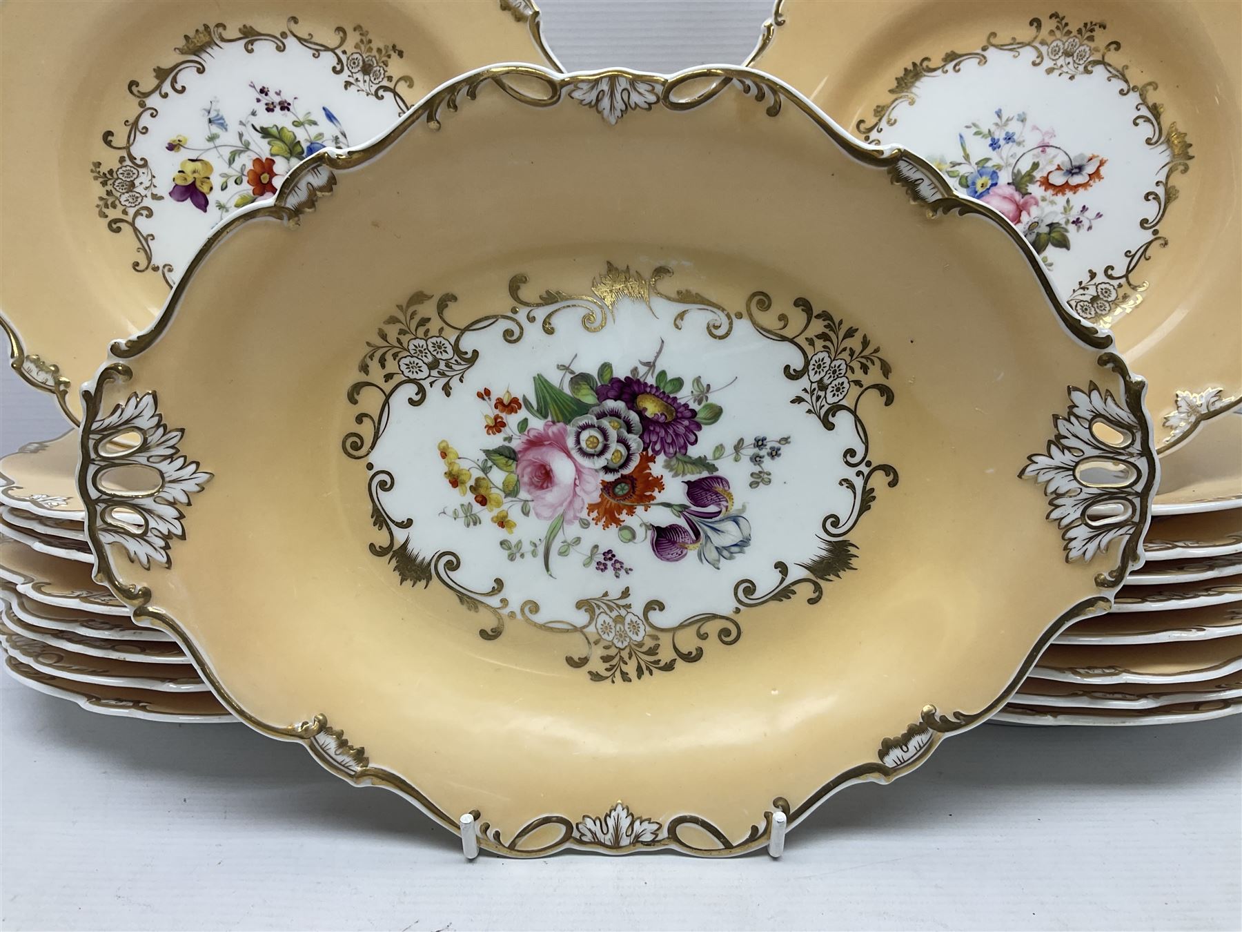Victorian part dessert service, including eighteen plates, four small serving dishes, shallow dish, etc hand painted with floral sprigs within a cream border with floral panels, and heightened in gilt (26cm)