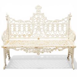 Victorian revival heavy cast iron garden bench, ornate back rest with scrolls, floral motifs and central crest, pierced lattice seat, curved arms and decorative legs, painted in antique white, in the Gothic Coalbrookdale style