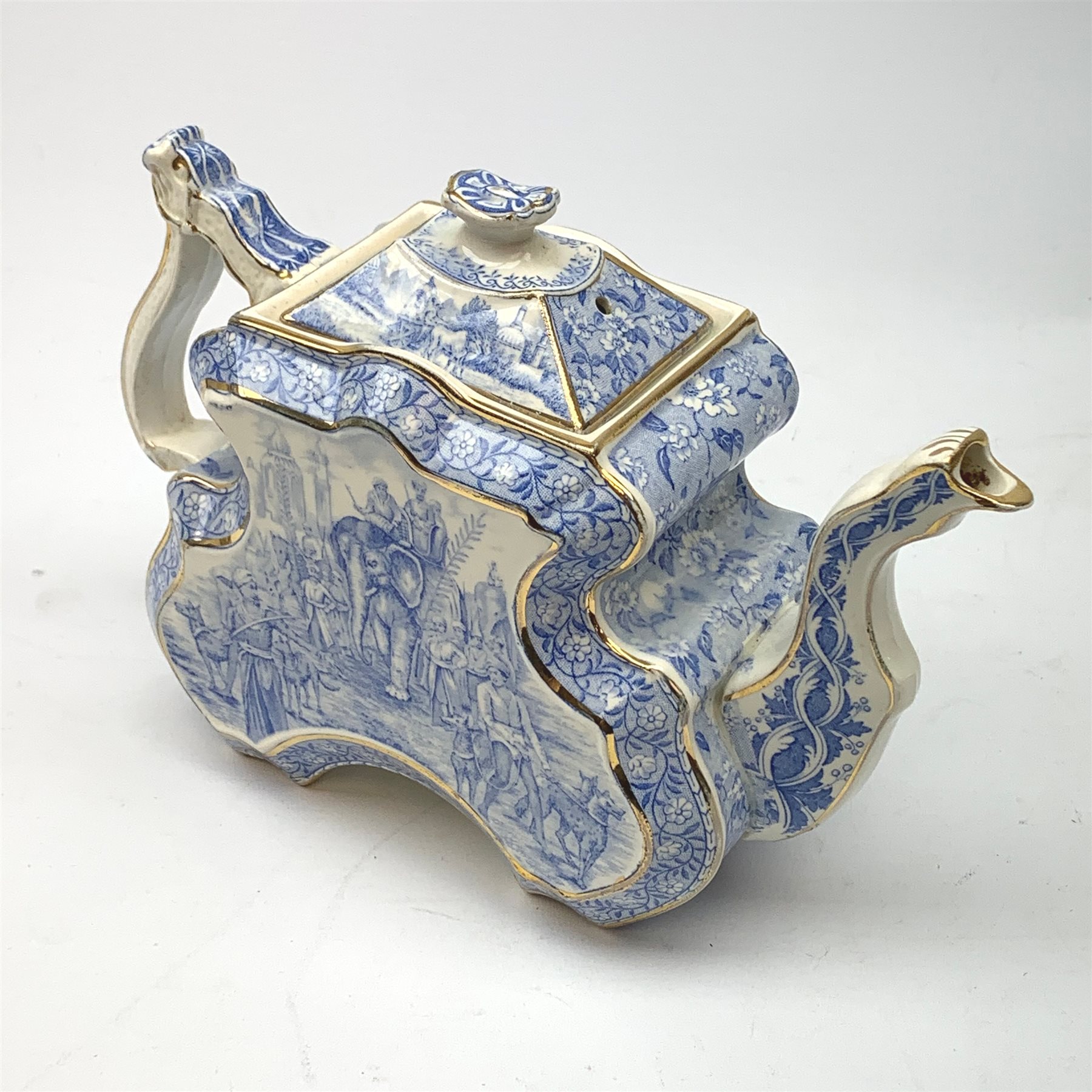 A Victorian Burgess and Leigh Aesthetic style blue and white teapot, decorated with an Indian hunting scene and heightened with gilt to edges, H17cm. 
