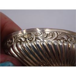 Pair of Victorian silver open salts, of part fluted navette form, with engraved foliate decoration, upon oval stepped foot, hallmarked W H Lyde, Birmingham 1896, H3.5cm, together with a pair of silver salt spoons, with leaf shaped bowls and ball finials, hallmarked Joseph Gloster, Birmingham 1897, together with a pair of Victorian silver open salts, of circular form, with shaped rim and embossed scroll and lattice decoration to the gilded bowl, together with pair of matching silver salt spoons, hallmarked Albert Sydenham, Birmingham 1899, both sets within tooled leather, velvet and silk lined fitted cases