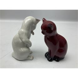 Royal Doulton flambé figure of a cat, together with a Bing and Grondahl Copenhagen model of a seated cat licking its paw, both with printed marks beneath, tallest example H13cm