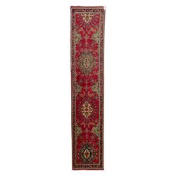 North West Persian Tabriz hand-knotted runner, madder red field with central octagonal med...