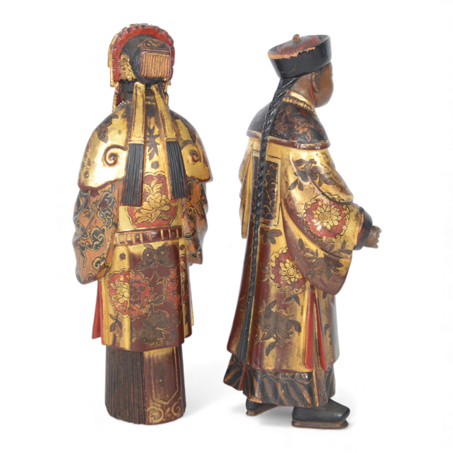 Pair of Asian carved wooden lacquered figures, in ceremonial dress, possibly wedding attire, highlighted throughout in gilt, H22cm