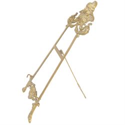 Three Baroque design brass table easels, the largest with cast mask detail, H47cm, and two matched graduated examples, smallest H25cm