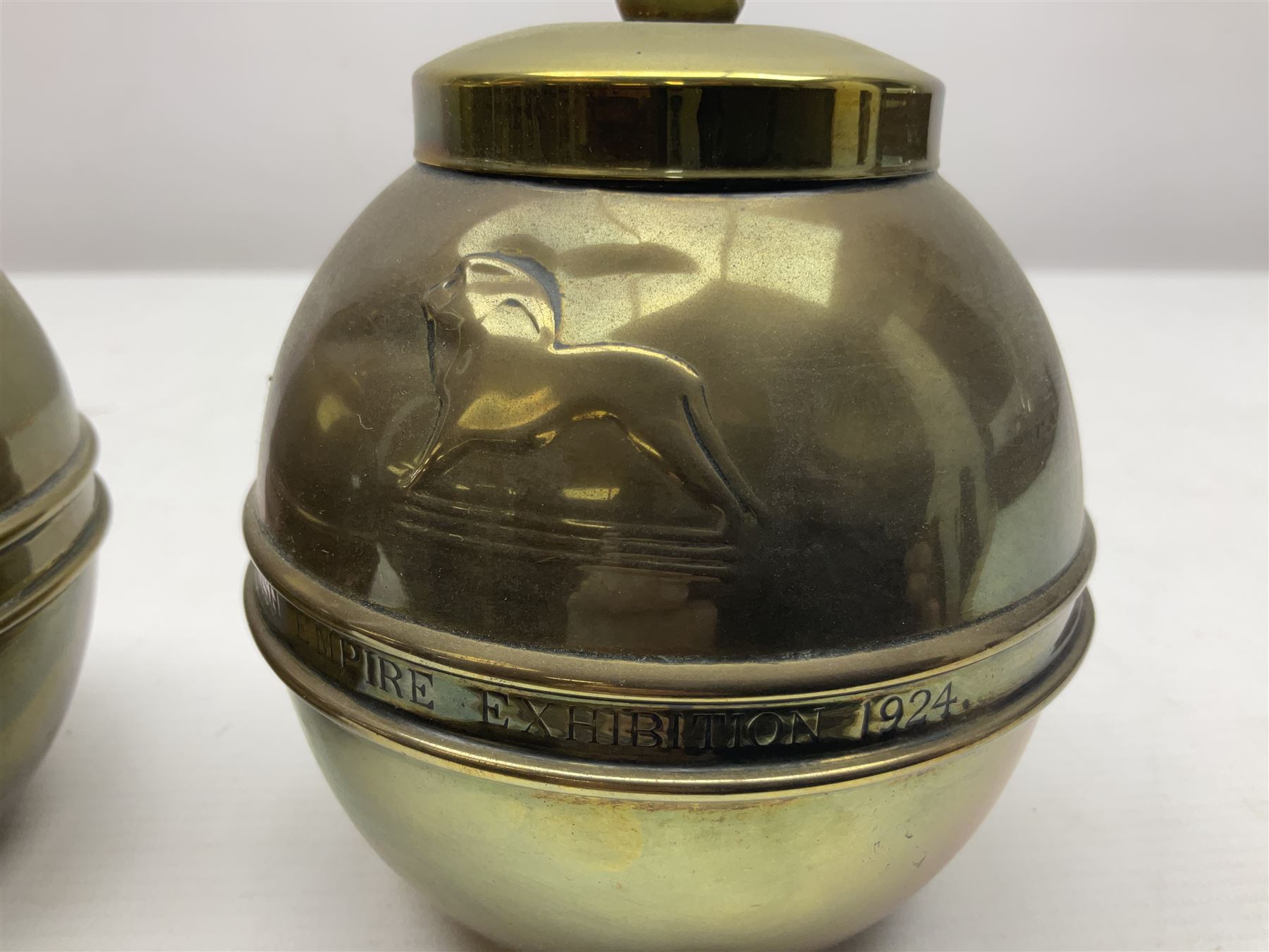 Pair of brass 1924 commemorative tea caddies, of ovoid form the waist embossed with 'British Empire Exhibition 1924' 'Lipton's Souvenir Tea Caddy', H18cm