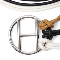 Hermès - long multi-cord belt in black, white and camel, suspending a large palladium-tone circular openwork H pendant, signed HERMES, in original box