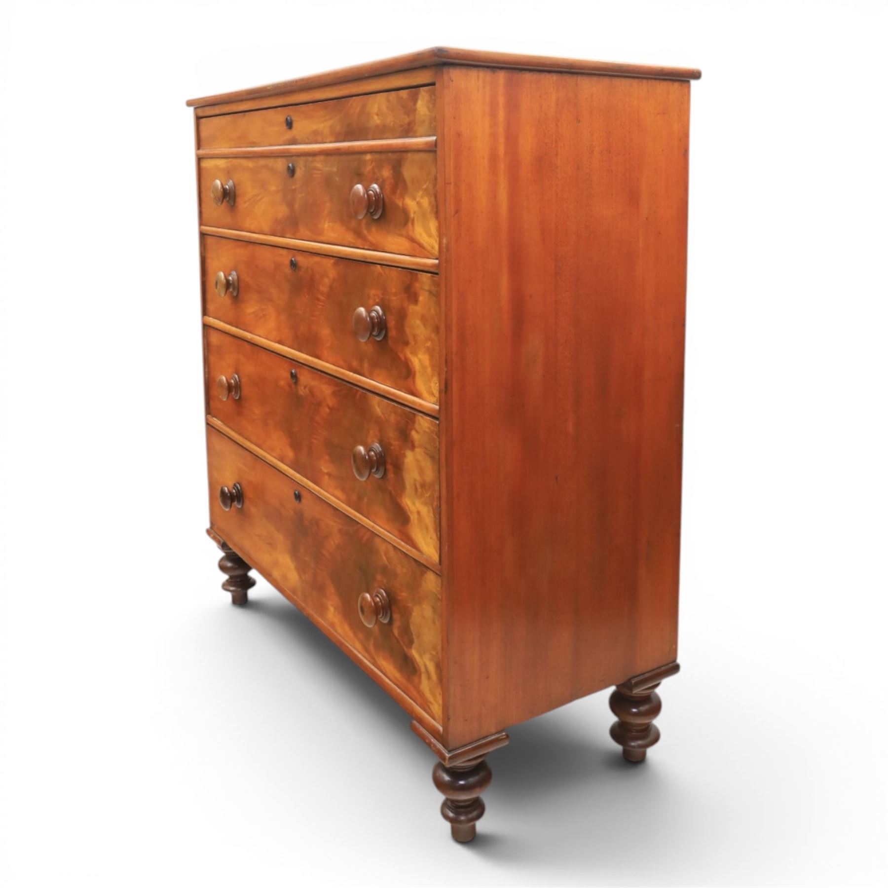 Victorian mahogany chest, with four long  flame mahogany fronted drawers with turned wooden knobs, raised on turned bun feet 