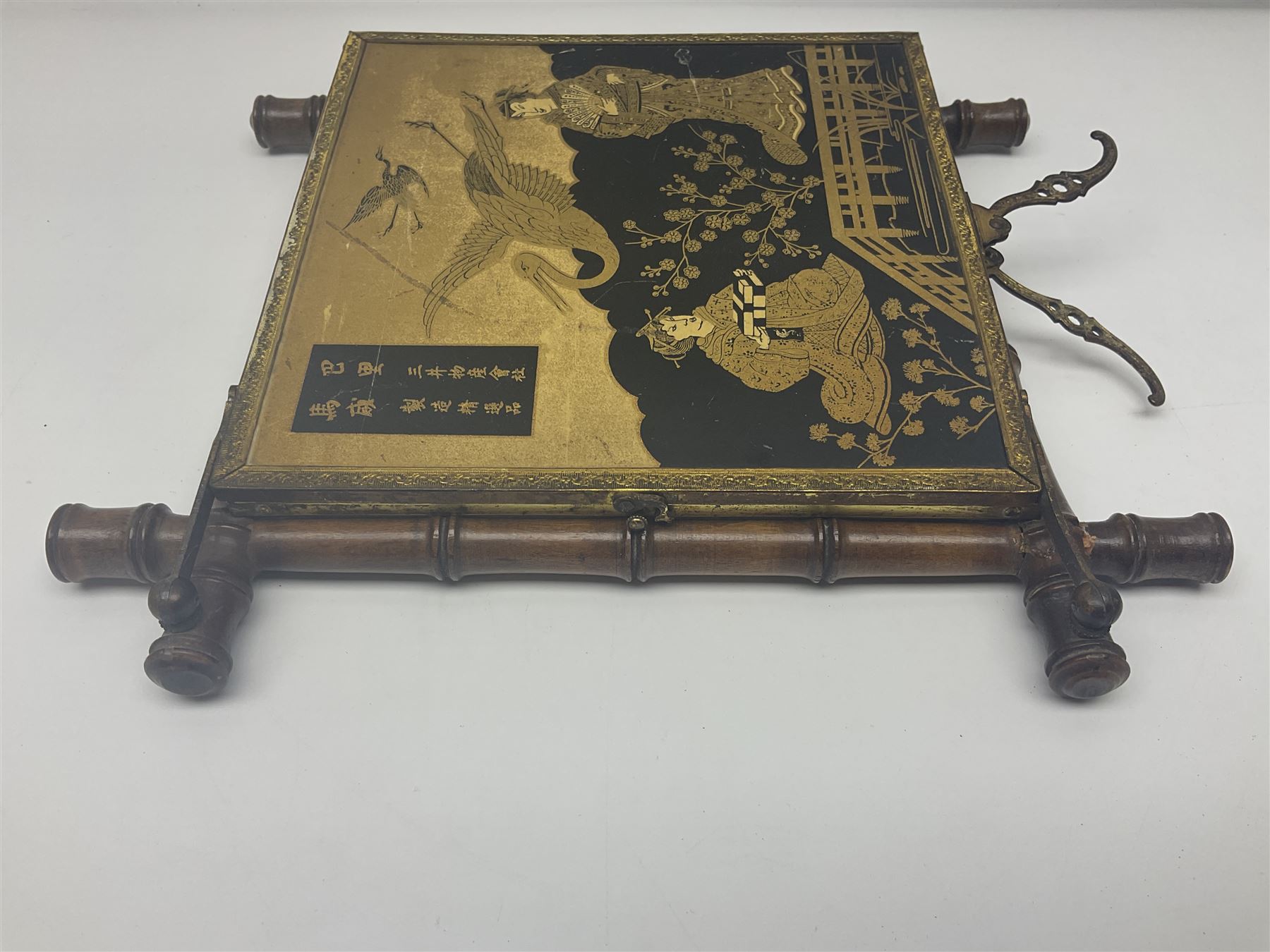 Japaneses triptych mirror, with two fold out panels with prints depicting egrets and figures in a garden with Japanese text, within a bamboo frame, H32cm
