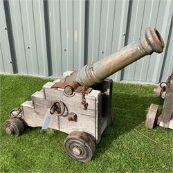 Pair of hardwood framed, cast iron barrel garden cannons, on metal wheels  - THIS LOT IS TO BE COLLECTED BY APPOINTMENT FROM DUGGLEBY STORAGE, GREAT HILL, EASTFIELD, SCARBOROUGH, YO11 3TX