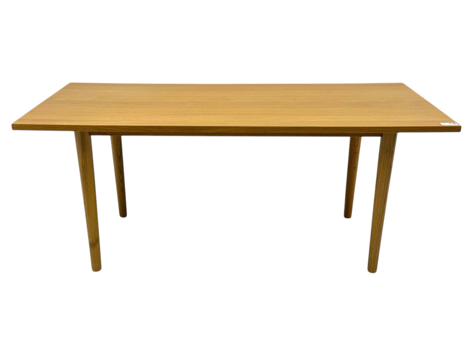 Ikea - Rectangular oak table, slim rectangular top over rounded edges, supported by tapered cylindrical legs  