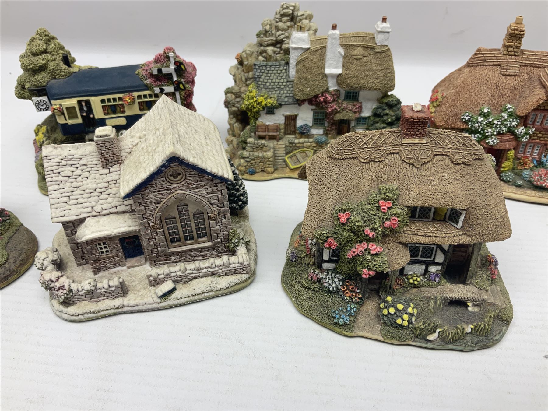 Eighteen Lilliput Lanes, including The Penny Farthing, The Pigsty, Borrowdale School, Fairy Cake Tearoom, An Apple a Day,Ladybird Cottage etc, all with original boxes 