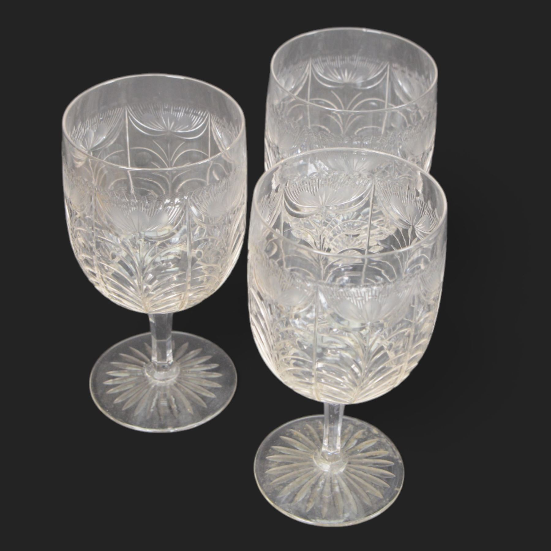 Six cut glass goblets, each with etched and cut floral decoration, together with eight similar bowls, a pair of Waterford Crystal glasses, eight champagne coupes etched with Greek Key border and four etched with floral border