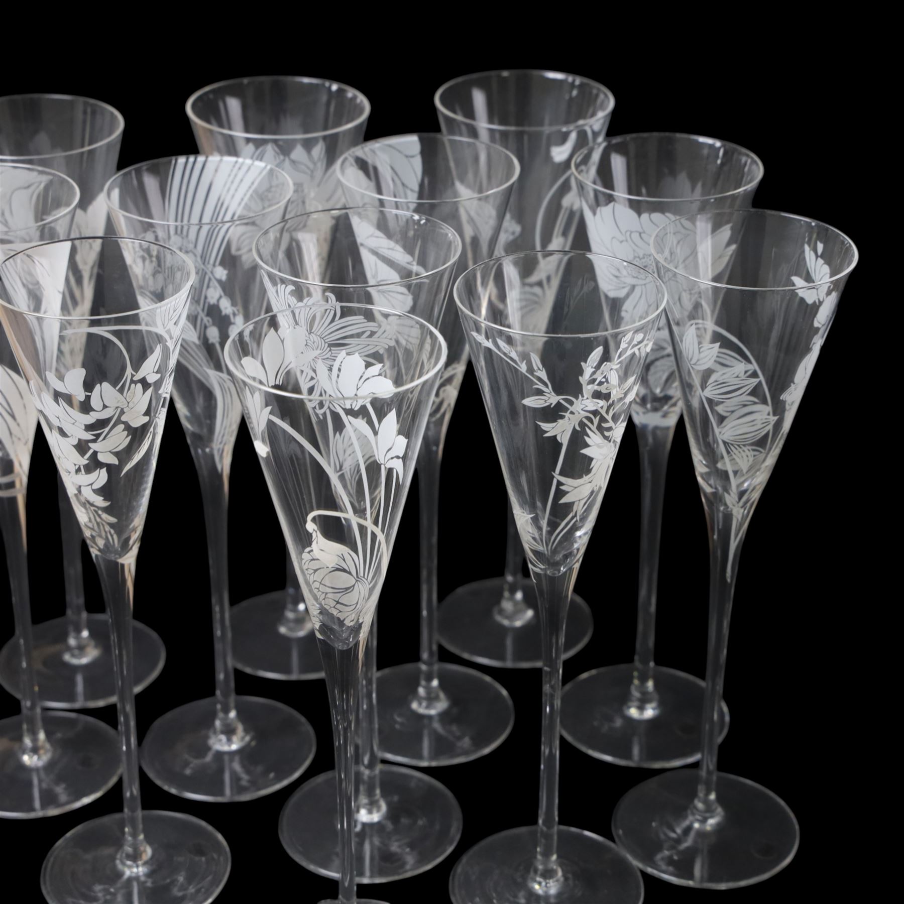 Twelve Crystal champagne glasses Les Fleurs, issued by the Franklin Mint in collaboration with Perrier Jouet, each glass is etched with a different flower, all boxed 