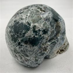 Carving of a skull in moss agate, H9cm, L12cm 