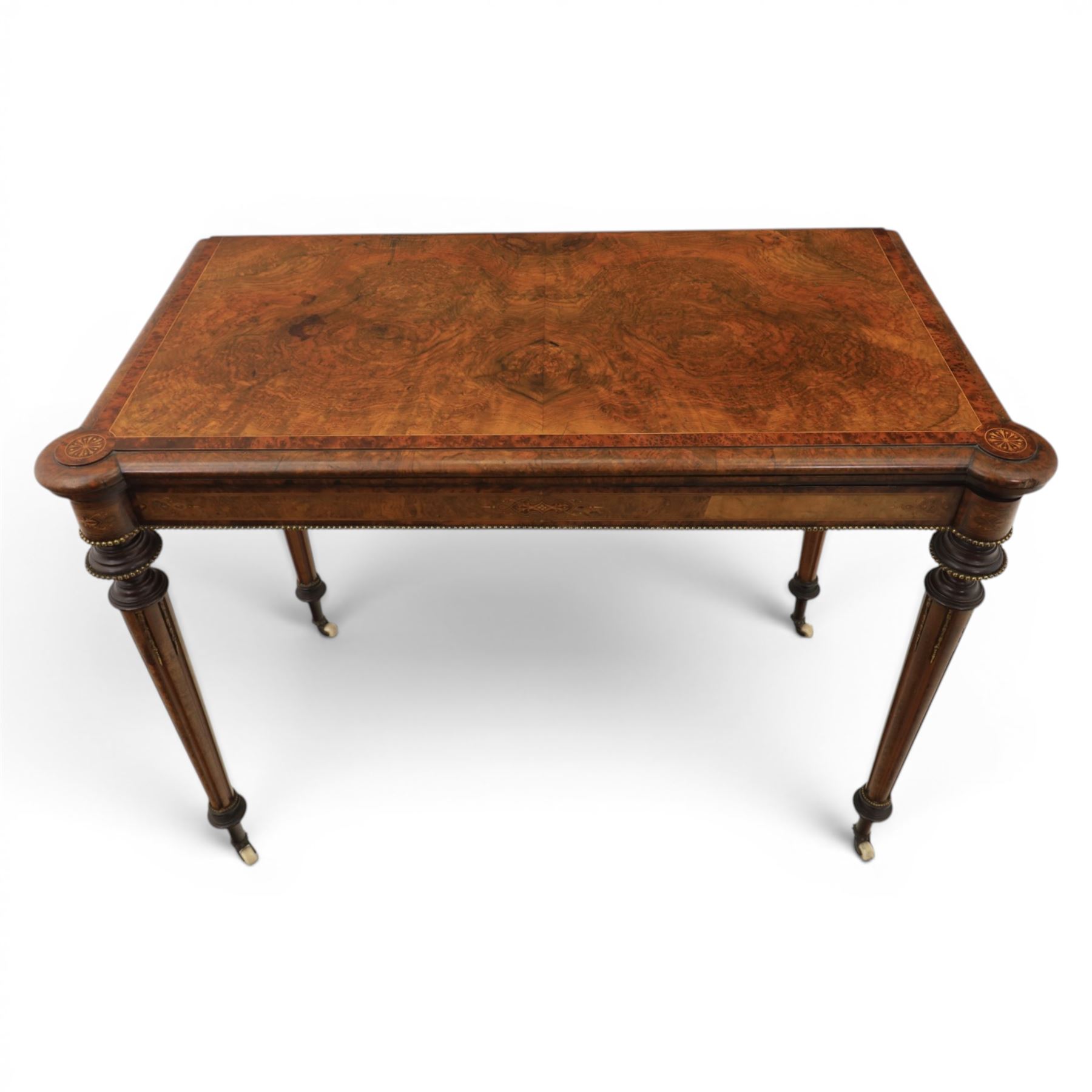 Victorian walnut card table, hinged rectangular moulded top with rounded corners and figured veneers, revealing a green baized lined interior, plain frieze with beaded lower edge, raised on ring turned tapering supports terminating in ceramic castors