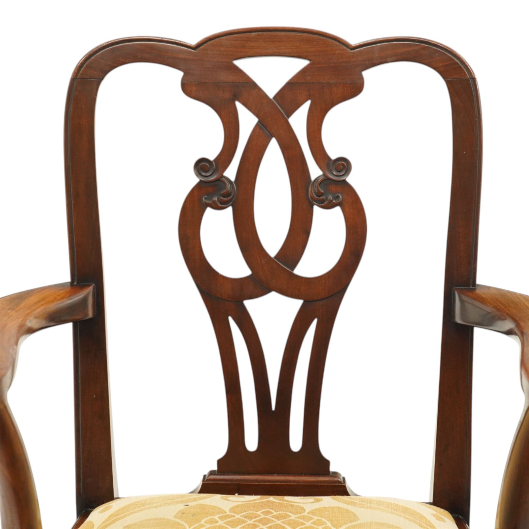 Late 19th century Chippendale style mahogany desk chair, with pierced splat and shaped and scrolled arms, raised on front claw and ball supports