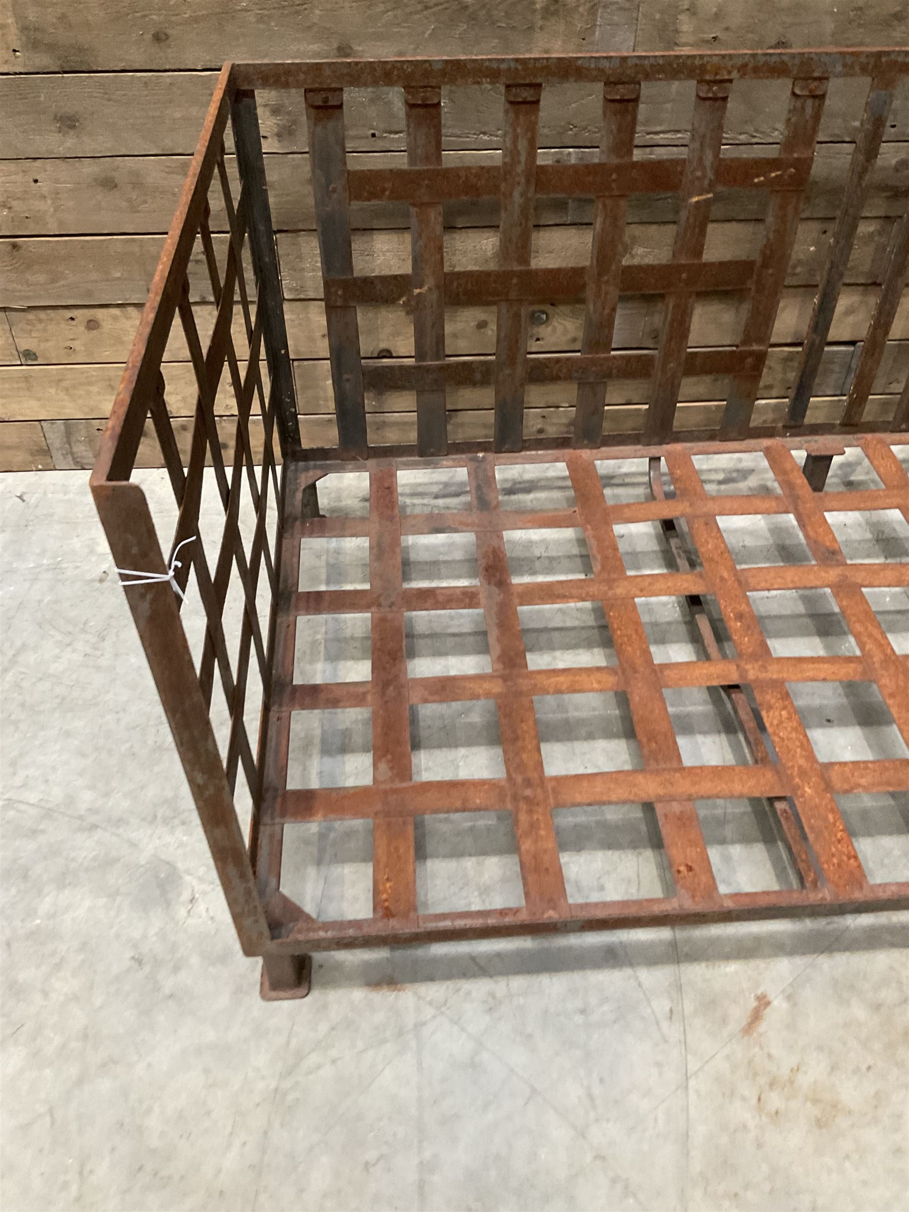 Wrought iron strapwork garden day bed, lattice back and sides