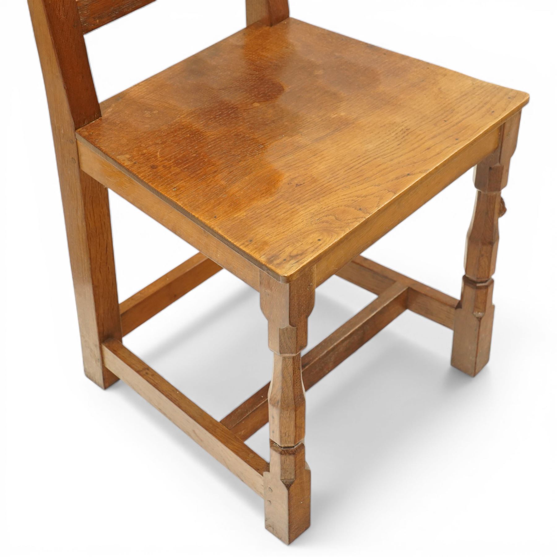 Mouseman - pair of oak panel back side chairs, adzed panel back and seat, on octagonal supports, with carved mouse signature, by the workshop of Robert Thompson of Kilburn