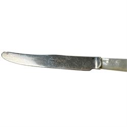 Collection of silver cutlery, including teaspoons, tablespoons, mother of pearl handled butter knife, fork and sugar tongs, all stamped or hallmarked