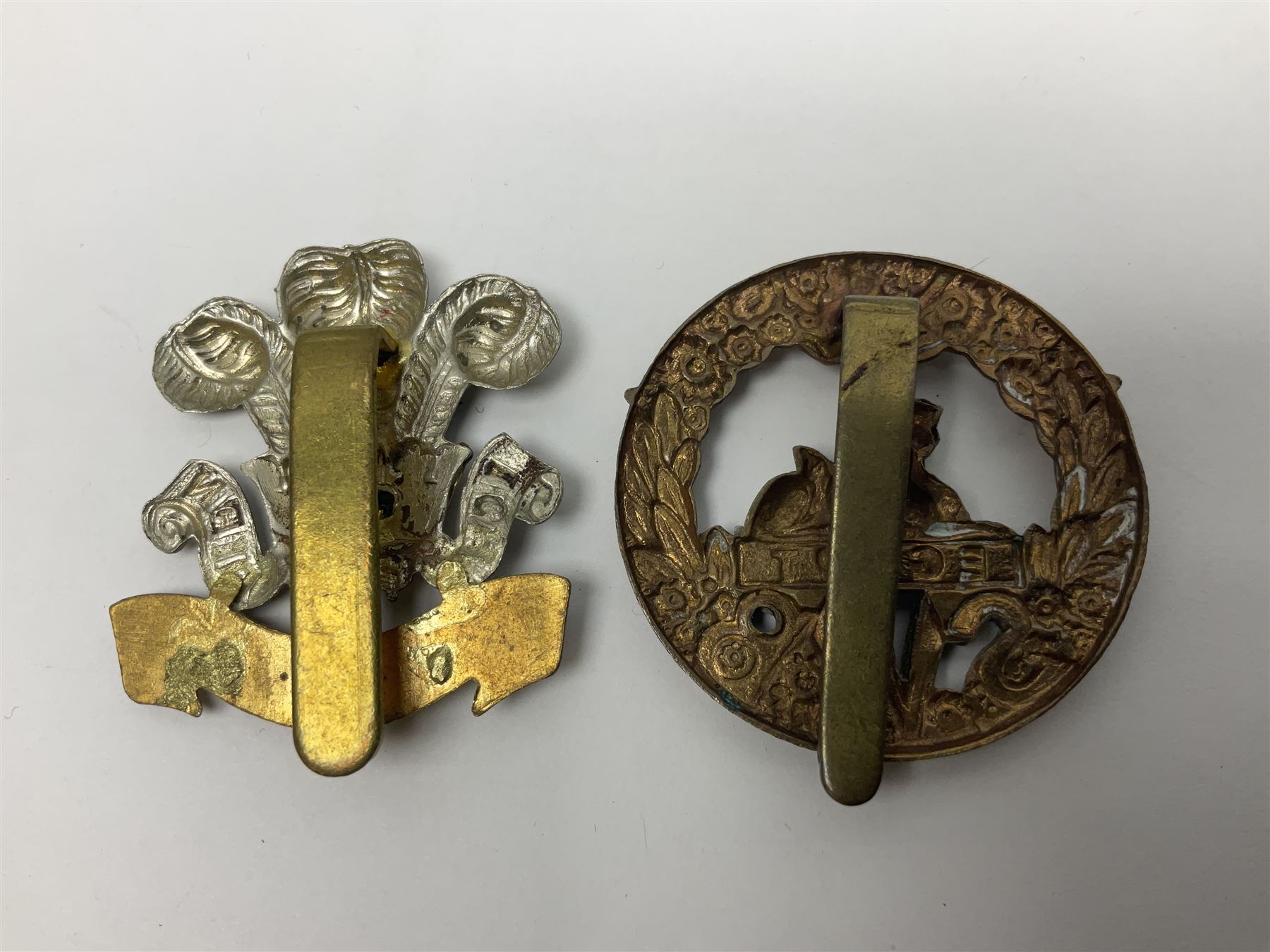 Fourteen cap badges of Irish interest including Royal Dublin Fusiliers inscribed to the slider 'From A. O'Connor 2nd Batt. Dec.2nd 1915', Connaught Rangers, South irish Horse Yeomanry, Inniskilling Fusiliers, Royal Irish Regiment etc; and seven Welsh badges including South Wales Borderers, Welsh Guards, 3rd Bn. Monmouthshire Regt. etc (21)