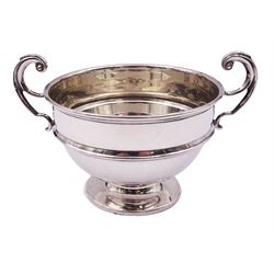 1920's silver twin handled bowl, of circular form with girdle and twin flying scroll handles, upon a spreading circular foot, hallmarked James Woods & Sons, Birmingham 1921, including handles H9cm bowl D10.5cm, approximate weight 4.34 ozt (134.9 grams)