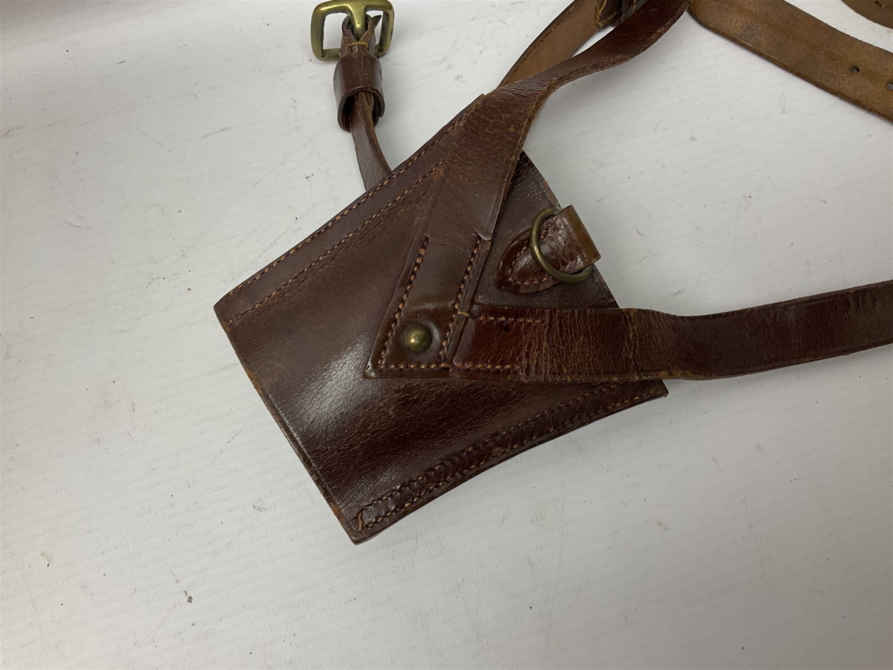 British Army General Staff officer's peaked cap by Herbert Johnson London in Moss Bros. delivery box; two officer's Sam Browne leather belts; leather pistol holster and sword hanger; pair of leather gloves and pair of spurs