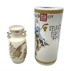Oriental cylindrical stick stand, decorated with an elder with a tiger and a boy riding a bull , together with a twin handled vase decorated with gilded birds and flowers