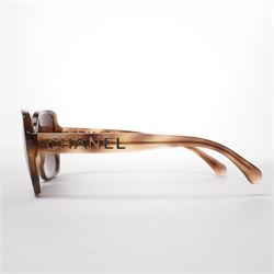 Chanel - pair of oversized sunglasses, with translucent tortoiseshell-effect brown acetate frames and gradient tinted lenses, the arms boldly set with gold-tone ‘CHANEL’ lettering, with original quilted leather case, booklet and box