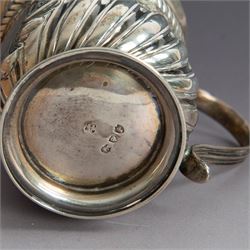 Victorian silver christening mug, of circular form with C scroll handle, embossed with scrolls and foliate decoration, with vacant oval cartouche to body, hallmarked John Aldwinckle & Thomas Slater, London 1890, contained within a tooled leather fitted case, mug H8cm