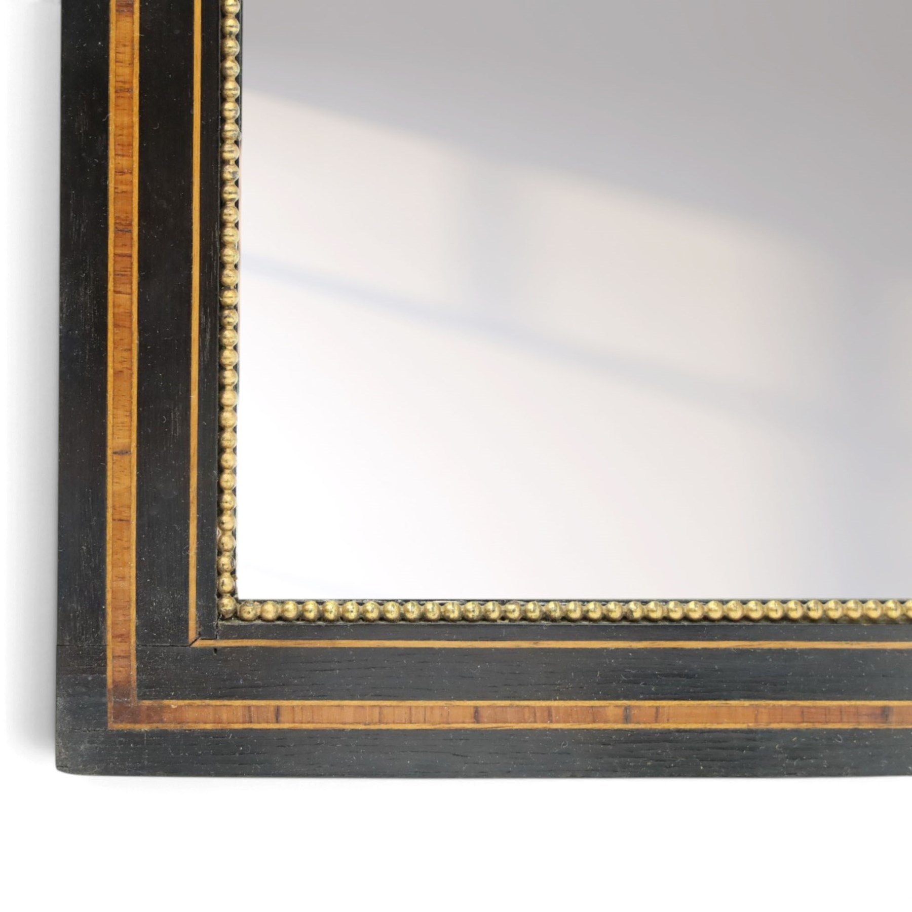 Edwardian mahogany heart-shaped wall mirror, bevelled mirror plate within a shaped frame, the rectangular surround decorated with satinwood crossbanding and burr walnut veneers, applied gilt decoration with hooks for hanging