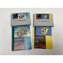 Two Super Nintendo Entertainment System (PAL) controllers, accessories and games. Super NES Game Commander with original box and instruction booklet, Super NES Nintendo Scope (1992) transmitter gun, receiver, Super NES Nintendo Scope 6 game with original instruction booklets. Further games to include ‘The Legend of Zelda a Link to the Past’, ‘Super Mario World’, ‘Super Mario Kart’, ‘The Lawnmower Man’, and ‘Exhaust Heat’, all with original instruction booklets. ‘PowerMonger’ and Disney’s ‘Aladdin’ game cartridges only 