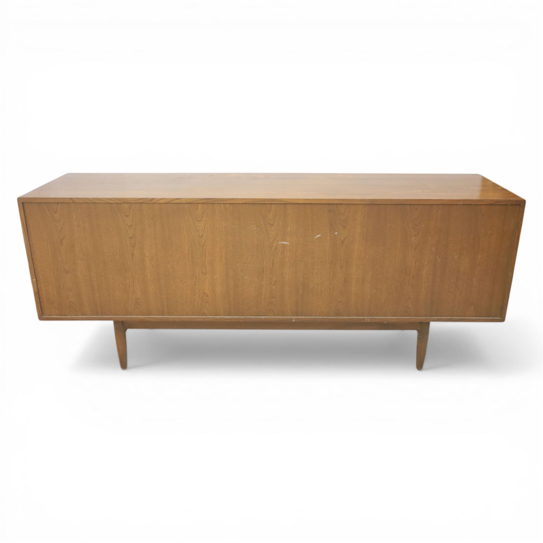 Ensign - Mid-20th century elm sideboard, with a central bank of four drawers, flanked by cupboard doors, raised on tapering supports, labelled Ensign Bristow & Townsend Ltd