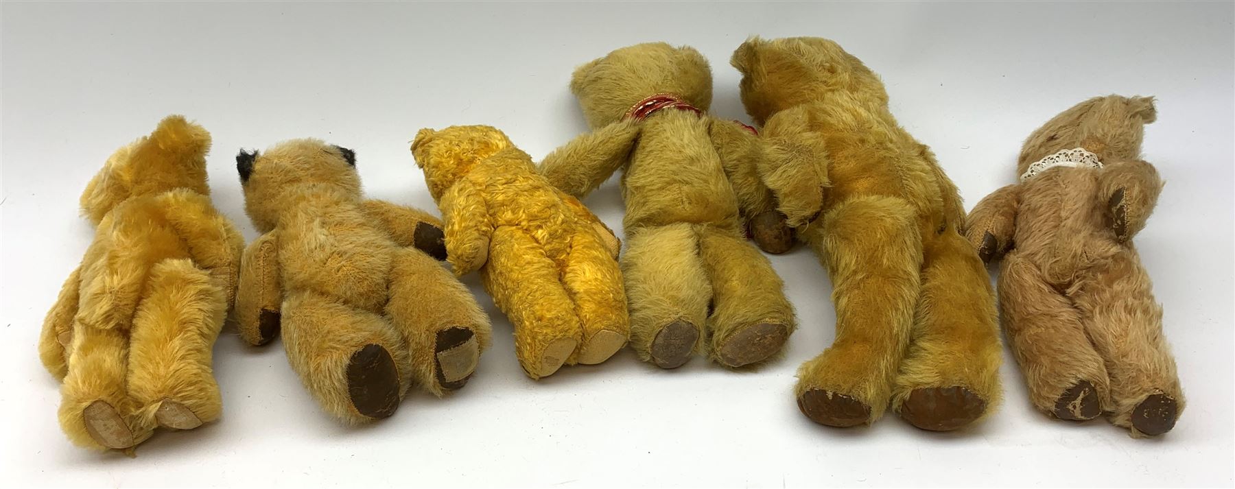 Six 1950s small teddy bears including Chad Valley Sooty type with glass type eyes, horizontal stitched nose and mouth and jointed limbs H9