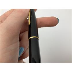 Montblanc 320 fountain pen, with black resin body, gold coloured clip and banding, and white emblem to cap terminal, the nib marked 585